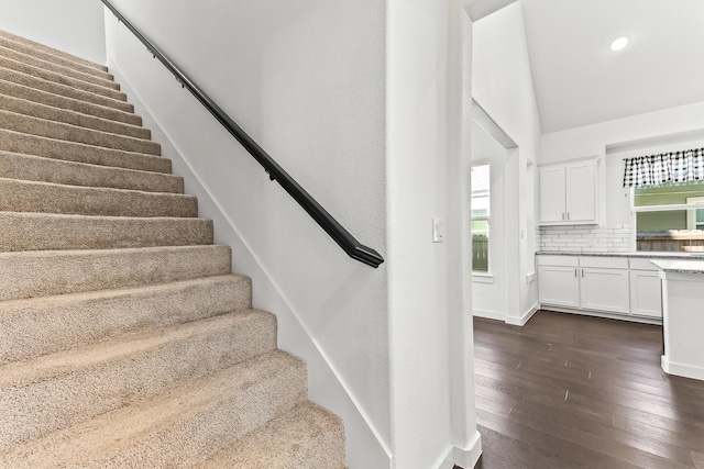 stairway with hardwood / wood-style flooring, recessed lighting, and vaulted ceiling