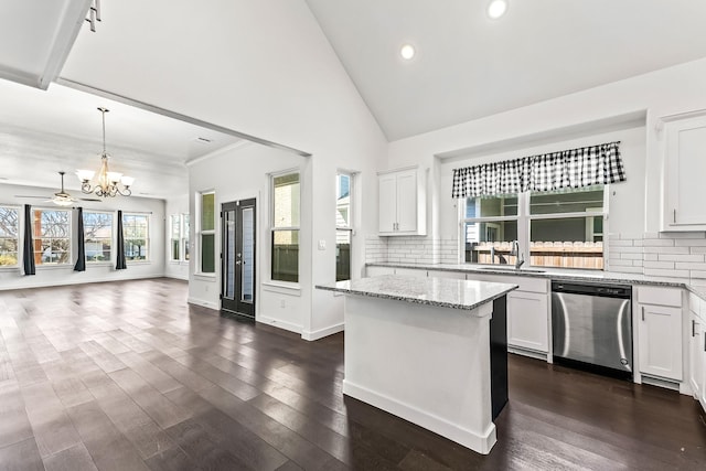 kitchen featuring white cabinetry, dark wood-style flooring, a sink, dishwasher, and open floor plan