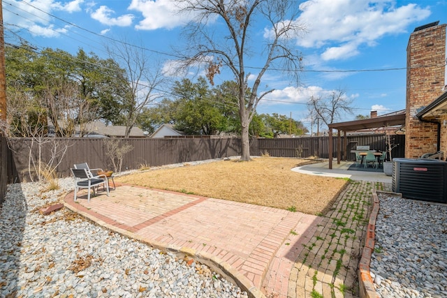 view of yard with cooling unit, a fenced backyard, and a patio area