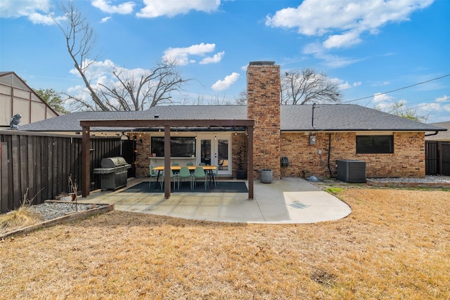 back of house with a patio, brick siding, central AC unit, and a fenced backyard