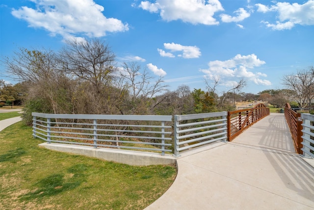 view of gate with a yard