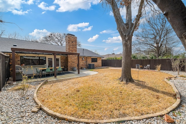 view of yard featuring a patio, central AC unit, and a fenced backyard