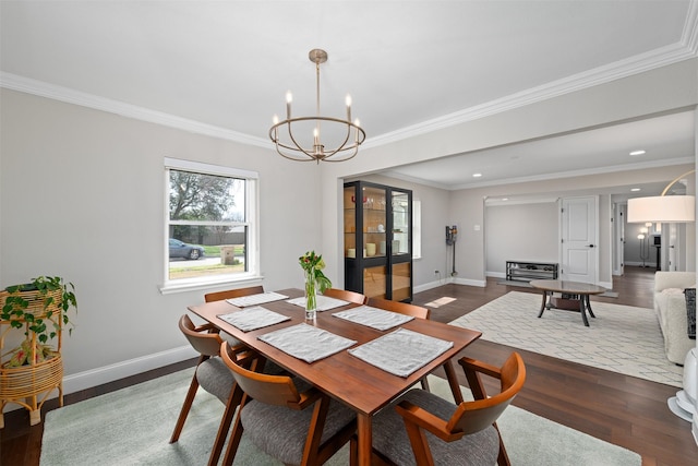 dining area with an inviting chandelier, crown molding, dark wood-type flooring, and baseboards