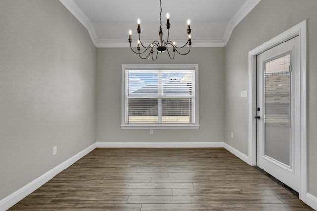 unfurnished dining area featuring baseboards, a notable chandelier, dark wood-style flooring, and crown molding