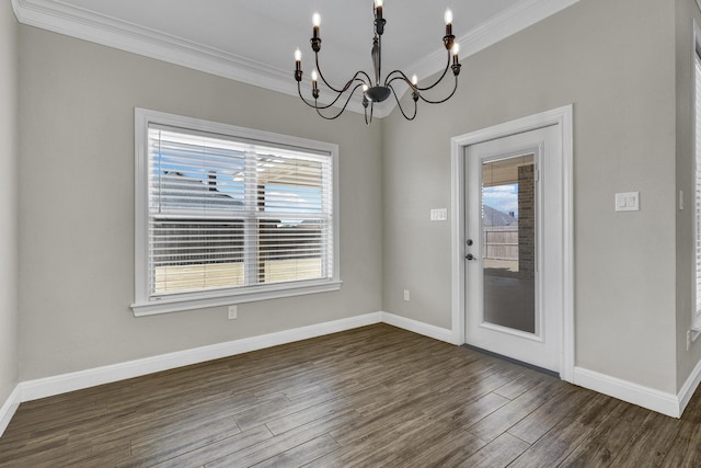 unfurnished dining area with an inviting chandelier, dark wood-type flooring, baseboards, and ornamental molding