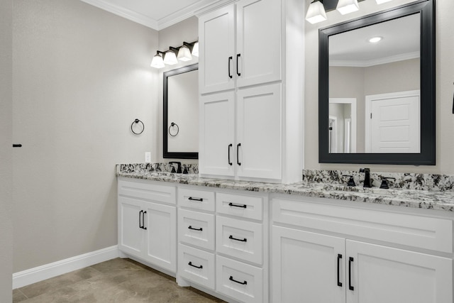 full bathroom with crown molding, double vanity, baseboards, and a sink