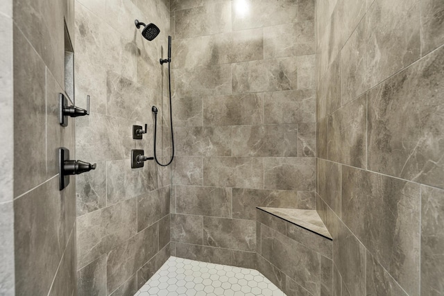 bathroom with a tile shower