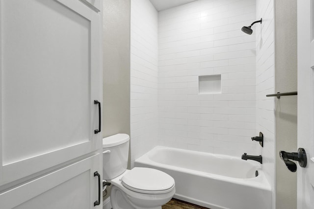 full bathroom with tub / shower combination, toilet, and wood finished floors