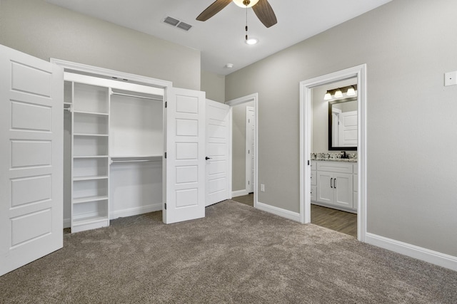 unfurnished bedroom featuring visible vents, connected bathroom, baseboards, carpet floors, and a closet