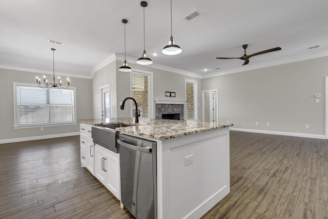 kitchen featuring open floor plan, a sink, visible vents, and stainless steel dishwasher