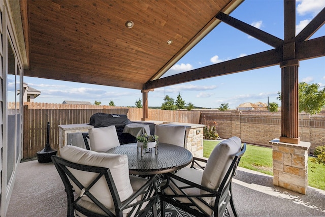 view of patio with a fenced backyard and outdoor dining space