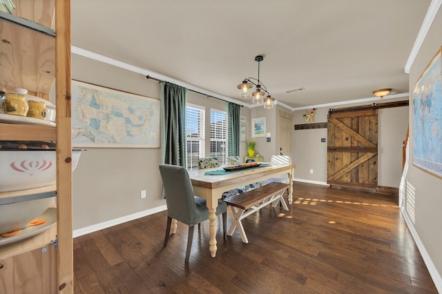 dining room featuring a barn door, visible vents, wood finished floors, and crown molding