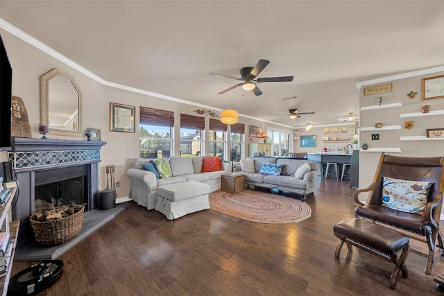 living room featuring a fireplace with raised hearth, wood-type flooring, baseboards, and ornamental molding