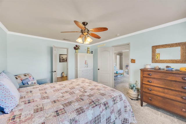 carpeted bedroom with visible vents, crown molding, and a ceiling fan