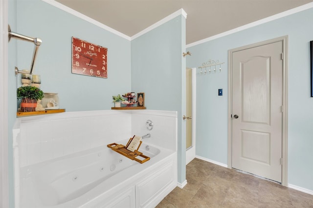 bathroom with baseboards, ornamental molding, and a whirlpool tub