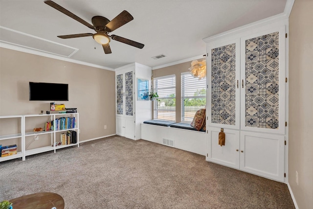 interior space with visible vents, carpet floors, attic access, and crown molding