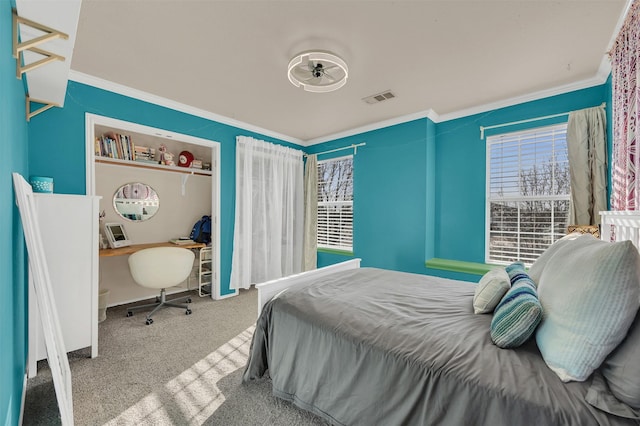 carpeted bedroom featuring visible vents, a closet, and crown molding