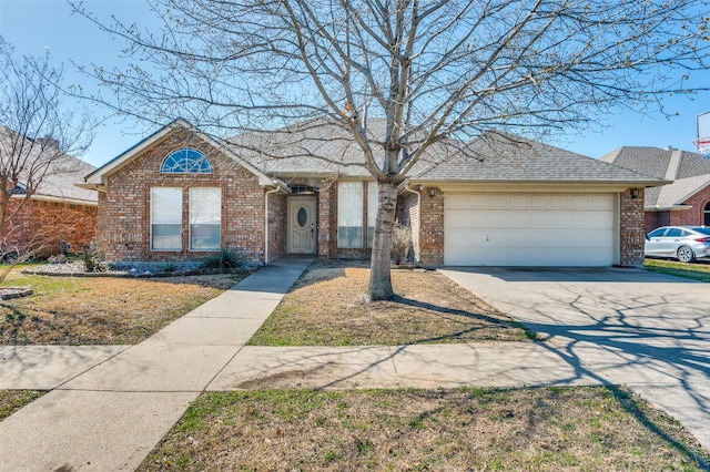 single story home featuring brick siding, a garage, driveway, and a shingled roof