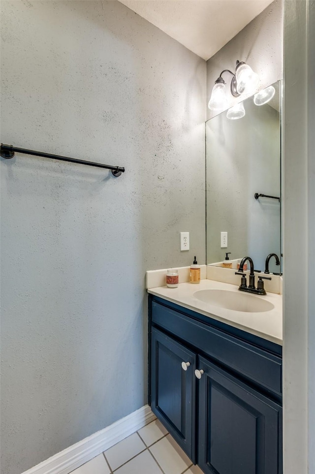 bathroom with tile patterned flooring, vanity, and baseboards