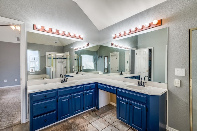 bathroom with vaulted ceiling, a shower stall, visible vents, and a sink