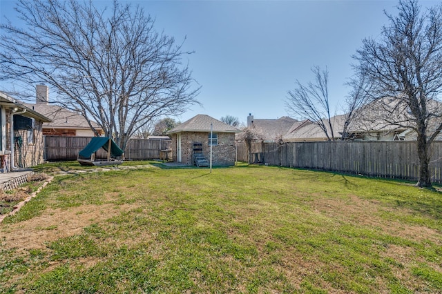 view of yard featuring an outbuilding and a fenced backyard