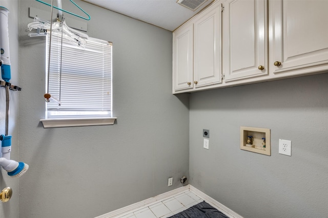 8304 Emerald Cir, North Richland Hills, TX 76180 - laundry room featuring hookup for an electric dryer, cabinet space, baseboards, hookup for a washing machine, and tile patterned flooring