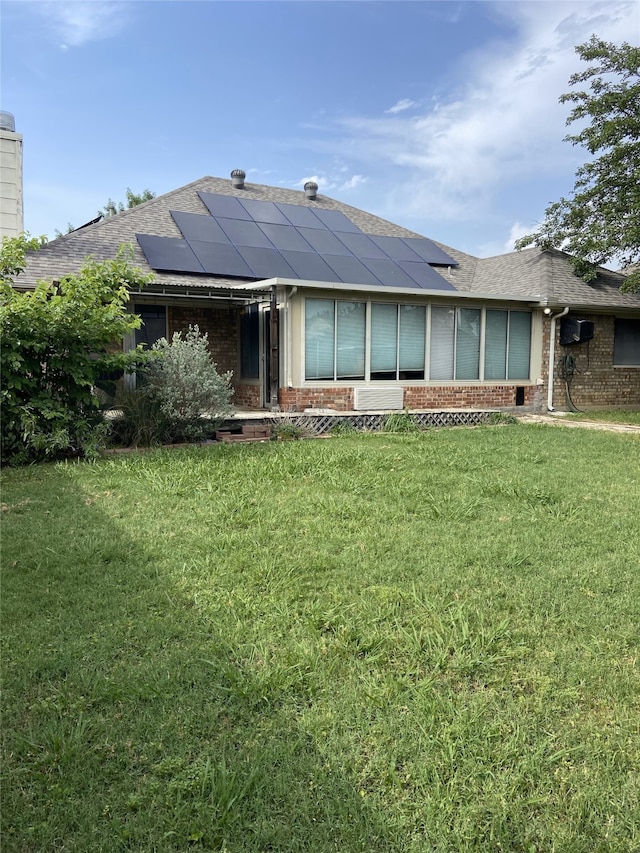 8304 Emerald Cir, North Richland Hills, TX 76180 - back of house with brick siding, a yard, and solar panels
