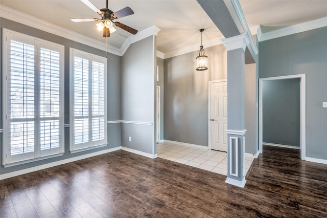 unfurnished room featuring ceiling fan, wood finished floors, ornamental molding, and ornate columns