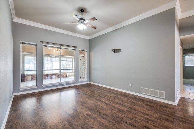 spare room featuring visible vents, crown molding, baseboards, ceiling fan, and wood finished floors