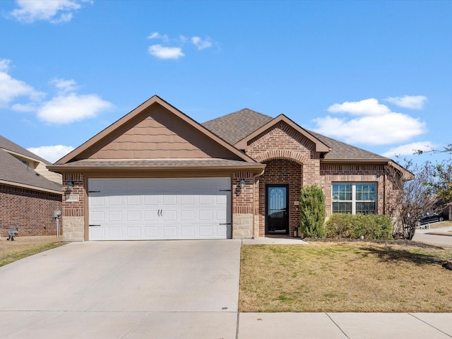 view of front facade featuring brick siding, a shingled roof, a front lawn, concrete driveway, and a garage