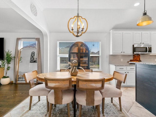 dining room with a chandelier, recessed lighting, and light tile patterned flooring