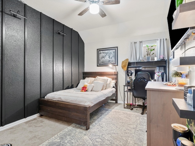 bedroom with vaulted ceiling, a ceiling fan, and light carpet