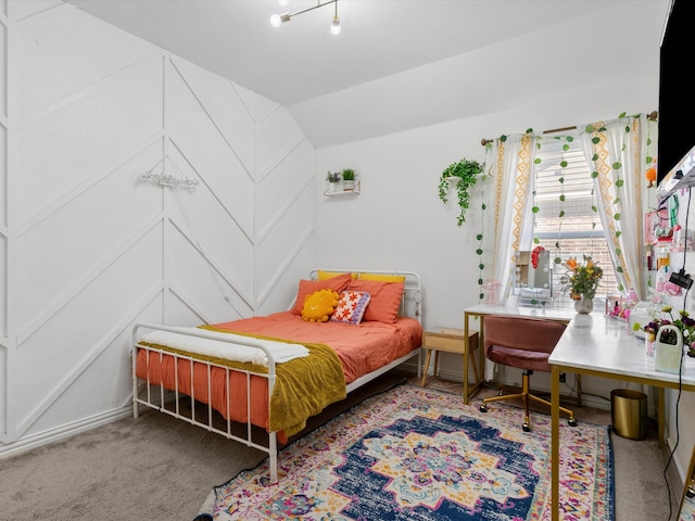 carpeted bedroom with lofted ceiling