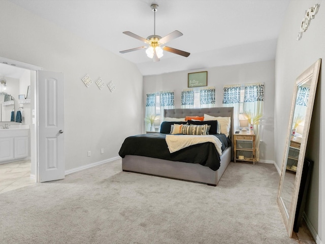 carpeted bedroom with baseboards, ensuite bath, a ceiling fan, and vaulted ceiling