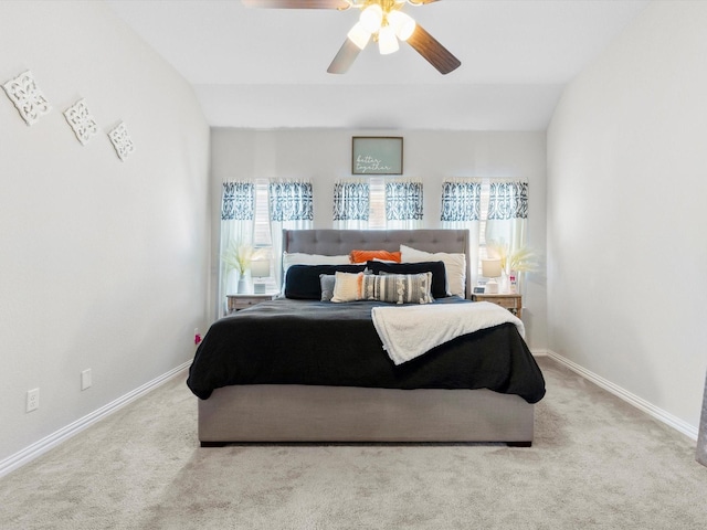 carpeted bedroom with lofted ceiling, baseboards, and ceiling fan