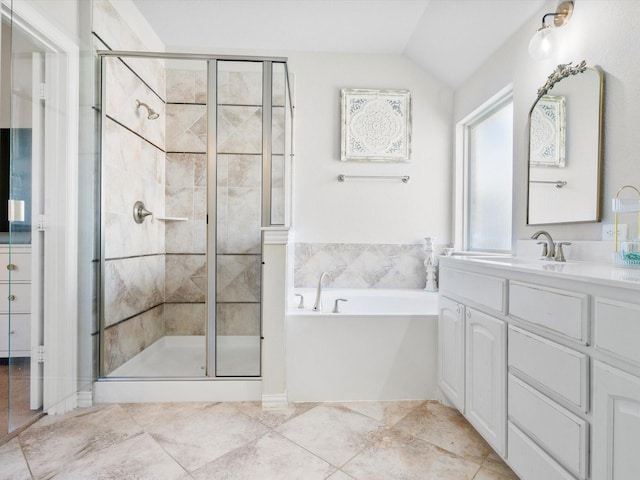 bathroom featuring lofted ceiling, a garden tub, vanity, and a shower stall