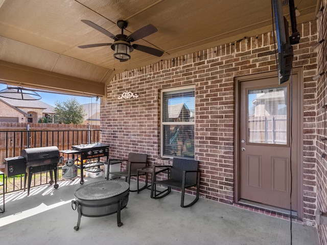 view of patio featuring grilling area, fence, and ceiling fan