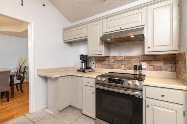 kitchen featuring stainless steel range with electric stovetop, under cabinet range hood, light tile patterned flooring, light countertops, and decorative backsplash