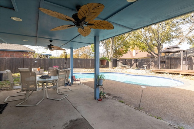 view of pool with a fenced in pool, outdoor dining area, a fenced backyard, a patio area, and a ceiling fan