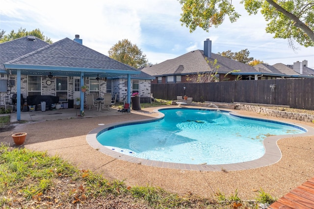 view of swimming pool with a patio, a fenced backyard, a fenced in pool, and ceiling fan