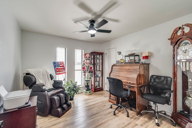 office space with light wood finished floors and ceiling fan