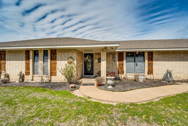 ranch-style house with brick siding and roof with shingles