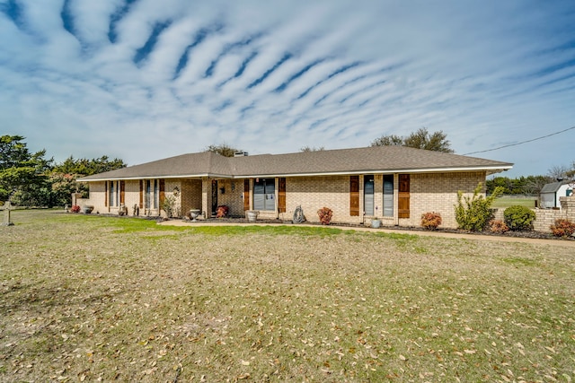 single story home with a front yard and brick siding