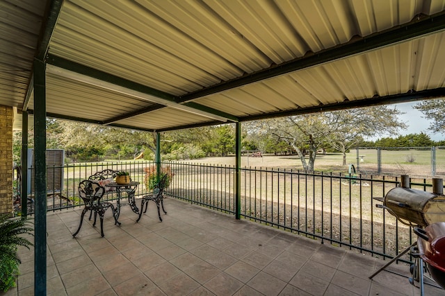 view of patio / terrace with a grill and fence