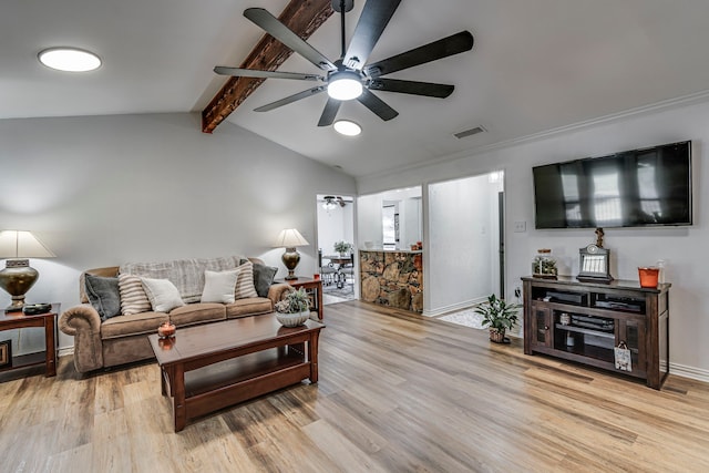 living area with visible vents, a ceiling fan, light wood-style flooring, and vaulted ceiling with beams