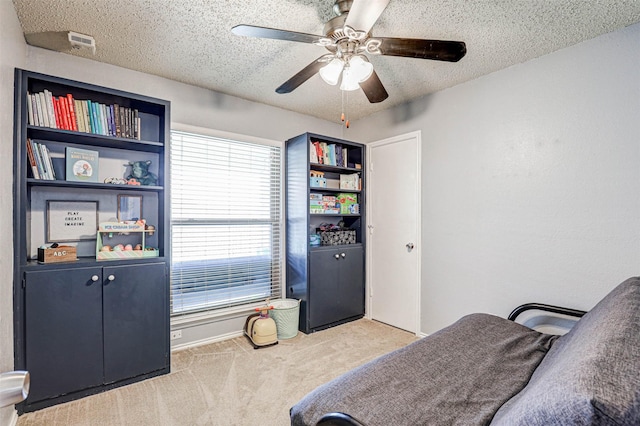 bedroom with carpet floors, a textured ceiling, and ceiling fan