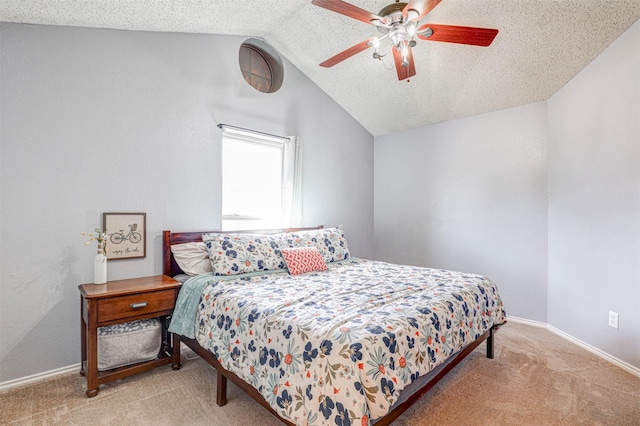 bedroom with a ceiling fan, carpet, baseboards, lofted ceiling, and a textured ceiling