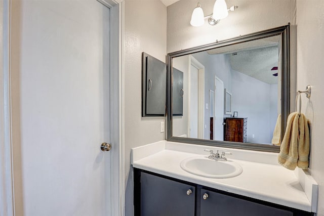 bathroom with vanity and a textured ceiling