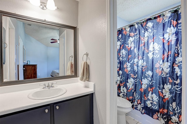 bathroom featuring a shower with curtain, toilet, a textured ceiling, ceiling fan, and vanity