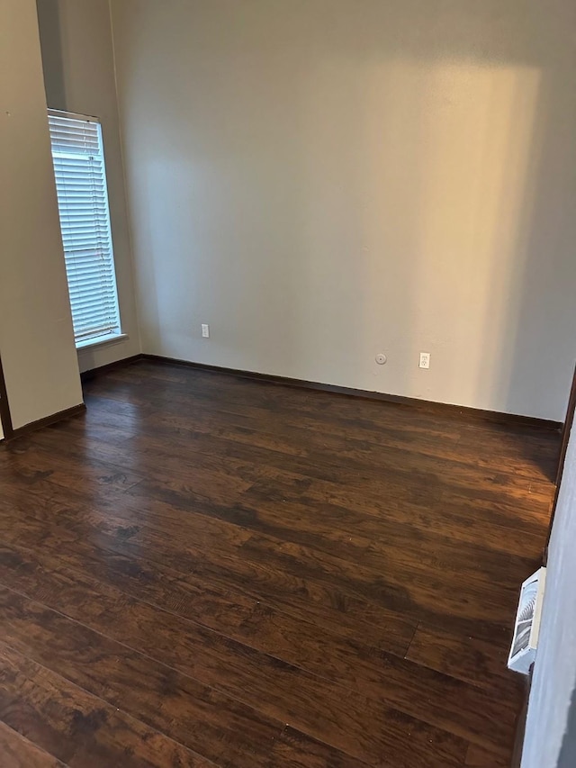 empty room with dark wood-style flooring